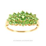 A 9 Carat Gold Ring With Multi Claw Set Peridots.