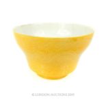 A Yellow Chinese Bowl With Markings To The Base.