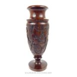 An African Ebony Vase With Carvings.