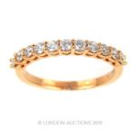 An 18 Carat Rose Gold Half Eternity Ring.