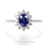 An 18 Carat White Gold Sapphire And Diamond Cluster Ring.