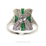 A Cubic Zirconia And Emerald Dress Ring.