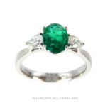 An 18 Carat Emerald And Diamond Three Stone Ring.