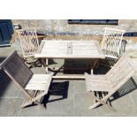 A Teak Folding Garden Table With Four Chairs.