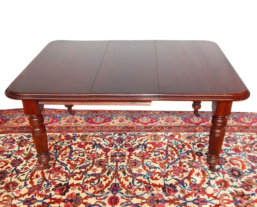 A VICTORIAN MAHOGANY WIND-OUT DINING TABLE.