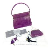 A Purple Crocodile Skin Christian Dior Handbag With Matching Clutch