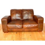 A Twin Seater Sofa in Brown Leather.