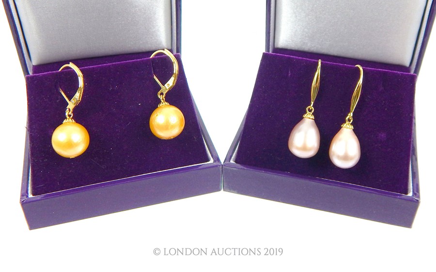 Two Pairs Of pearl Drop Earrings.