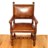 A 17th Century Style Leather Upholstered Elm Arm Chair.