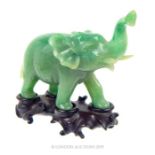 A Jade Indian Elephant on a Hardwood Stand.