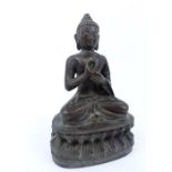 A Chinese Bronze Of A Buddha