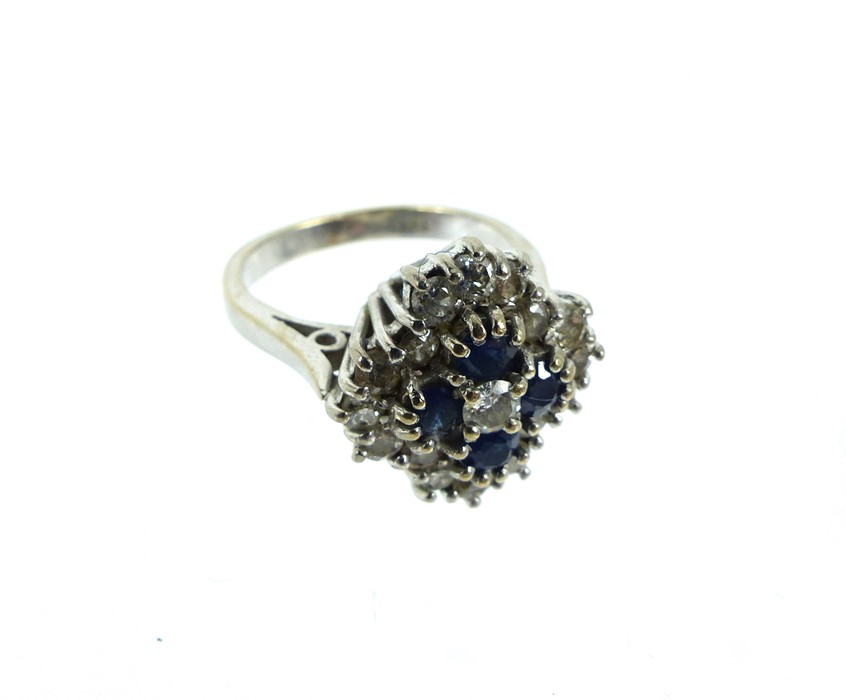 A Large 18ct White Gold Stepped Cluster Ring With Dark Sapphire And Diamond