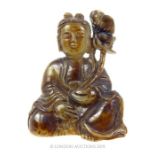 A Chinese Early Qing Period Buddha Cradling Lotus Flowers