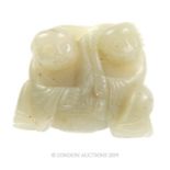 A Chinese Qing Jade Statuette Depicting Two Figures And A Lotus Leaf