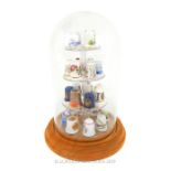 A Dome Display Cabinet With Various Thimbles