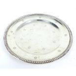 A Sterling Silver Salver With Impressed Floral Patterns