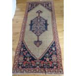 A large Persian rug with a central cream medallion