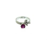 A 14 Carat White Gold Ruby And Diamond Cross Over Ring.