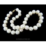 A Stunning 18 inch Baroque AAA 11-12mm White Pearl Necklace with 14 carat clasp.