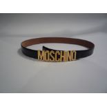 MOSCHINO - Made in Italy - CEINTURE en cuir noir. Boucle en méta doré. T.52. Long. [...]