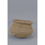 A stoneware Neolithic pot. 8cm tall