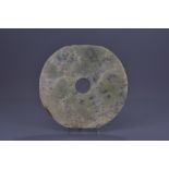 A large Chinese Neolithic or later jade disc head.