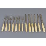 A set of silver knives and forks 20cm length