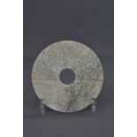 A Chinese Han Dynasty jade disc. 14cm diameter