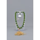 A green stone, possibly nephrite jade beaded neckl