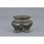 A small Chinese bronze three-legged desk censer wi