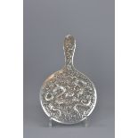 A 19th century Chinese silver mirror with dragon d