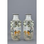 A mirrored pair of Chinese porcelain vases decorated with horses by artist Zhang Zhishang (1948/1960