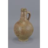 A 17th century stoneware Bellarmine jug with good