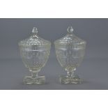 A pair of Victorian cut glass comports and covers