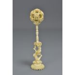 A Chinese 19th century ivory puzzle ball on a carv