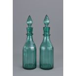 A pair of Aqua Green liquor glass bottles with sto