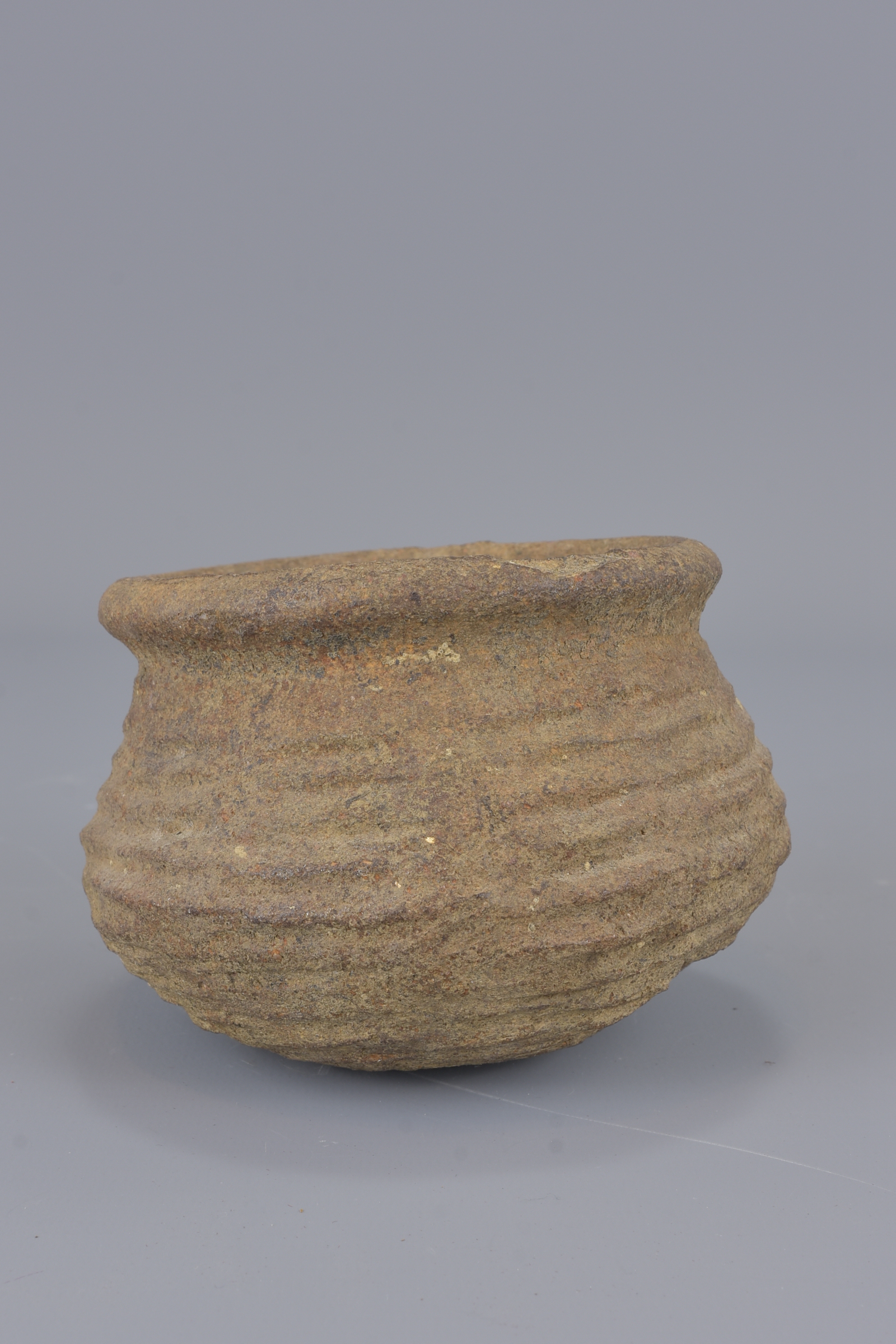 A stoneware Neolithic pot. 8cm tall - Image 3 of 5