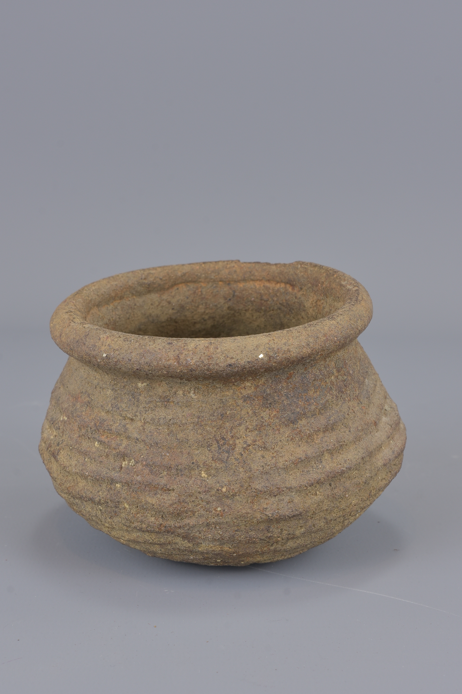 A stoneware Neolithic pot. 8cm tall - Image 2 of 5