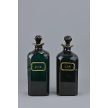 A pair of Emerald green glass gin and rum bottles