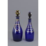 Two Blue glass liquor bottles with stoppers – Holl