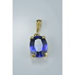 Gold colour pendant with tanzanite stone.