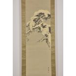 A Japanese ink painting in scroll depicting a pine