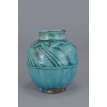 An Islamic Medieval turquoise glazed vase. 22cm he