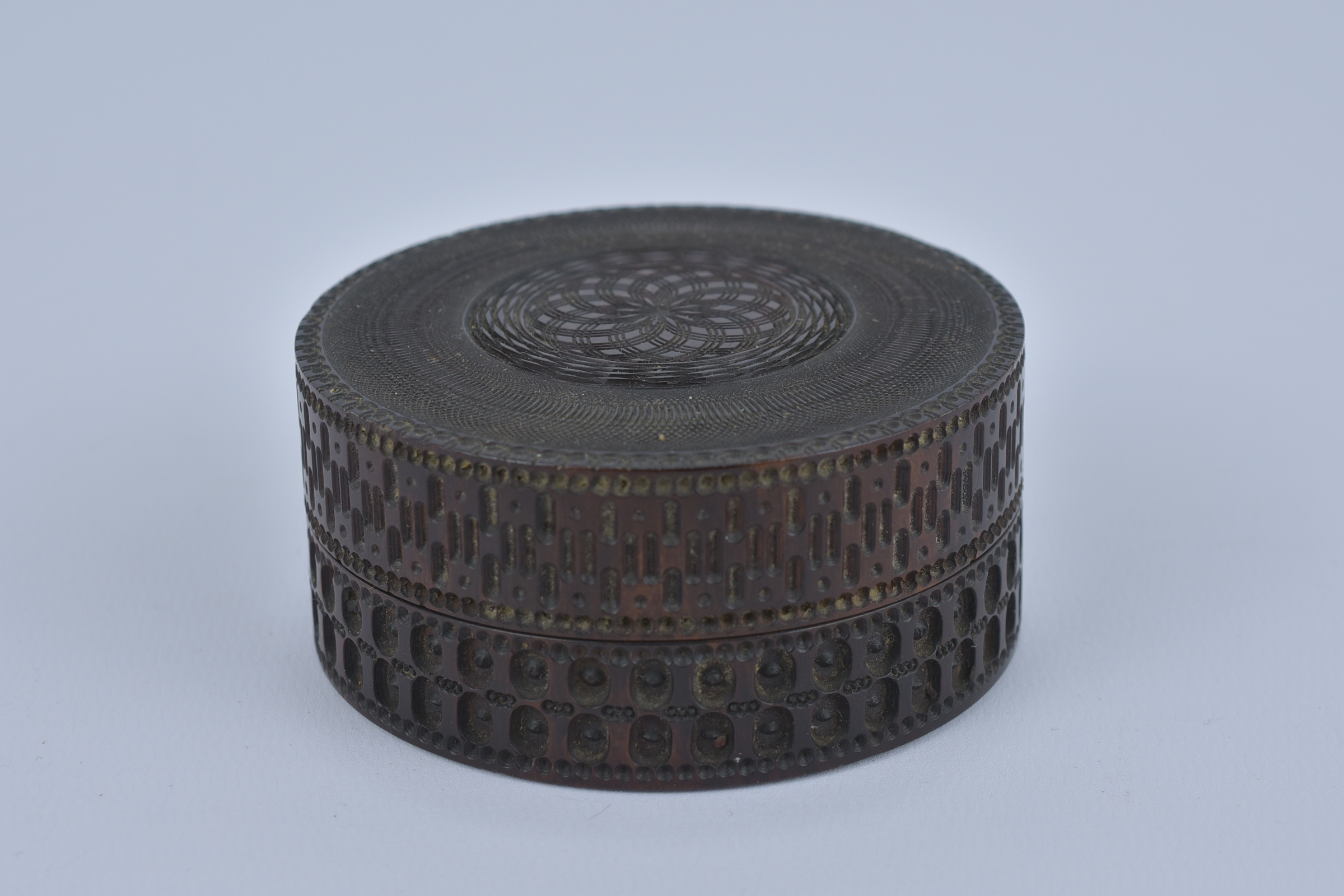 A 19th Century Sri Lankan Hardwood Box and cover with geometric design. 8cm diameter x 3.5cm height