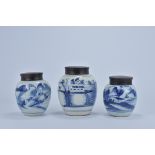 Three 18th Century Chinese blue and white porcelain jars decorated with village scenes with wooden c