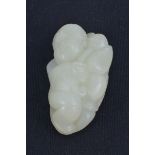 A Chinese White Jade carving of a Child. 5.5cm