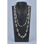 A string of graduated antique rock Crystal beads in a necklace.