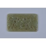 A Chinese carved Jadeite plaque carved and pierced with Birds and foliage. 10cm x 6cm