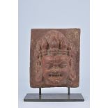 A Nepalese carved Sand Stone head on later stand (crack to stone bottom right corner) 22cm with stan