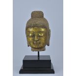 A Chinese carved gilt stone Buddha head on later stand. 37cm tall with stand